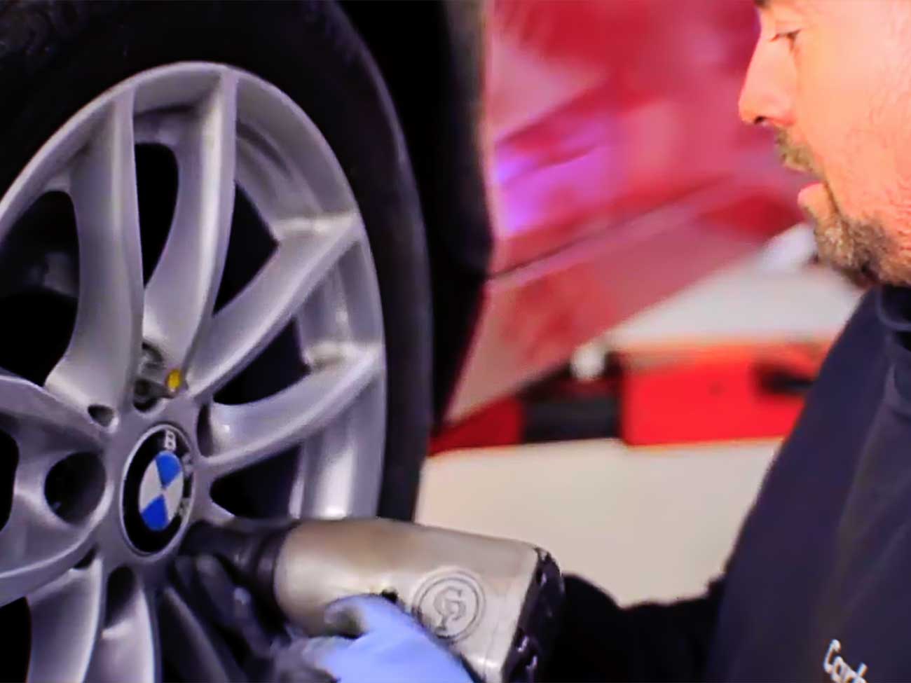 Mechanic inspecting a BMW wheel