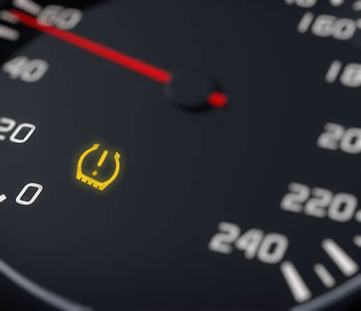 Tyre pressure warning light on car dashboard