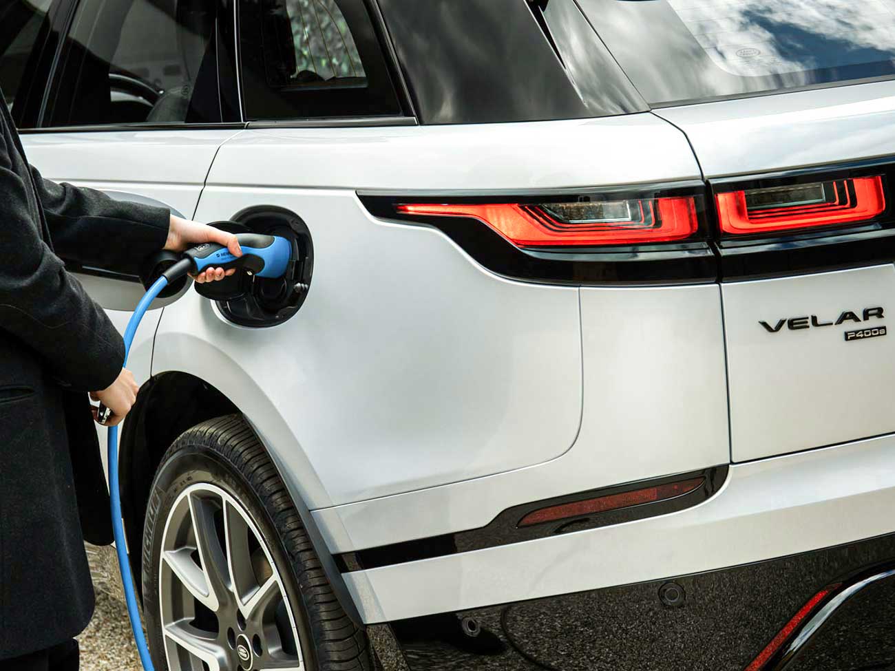 White Electric SUV plugged in and charging